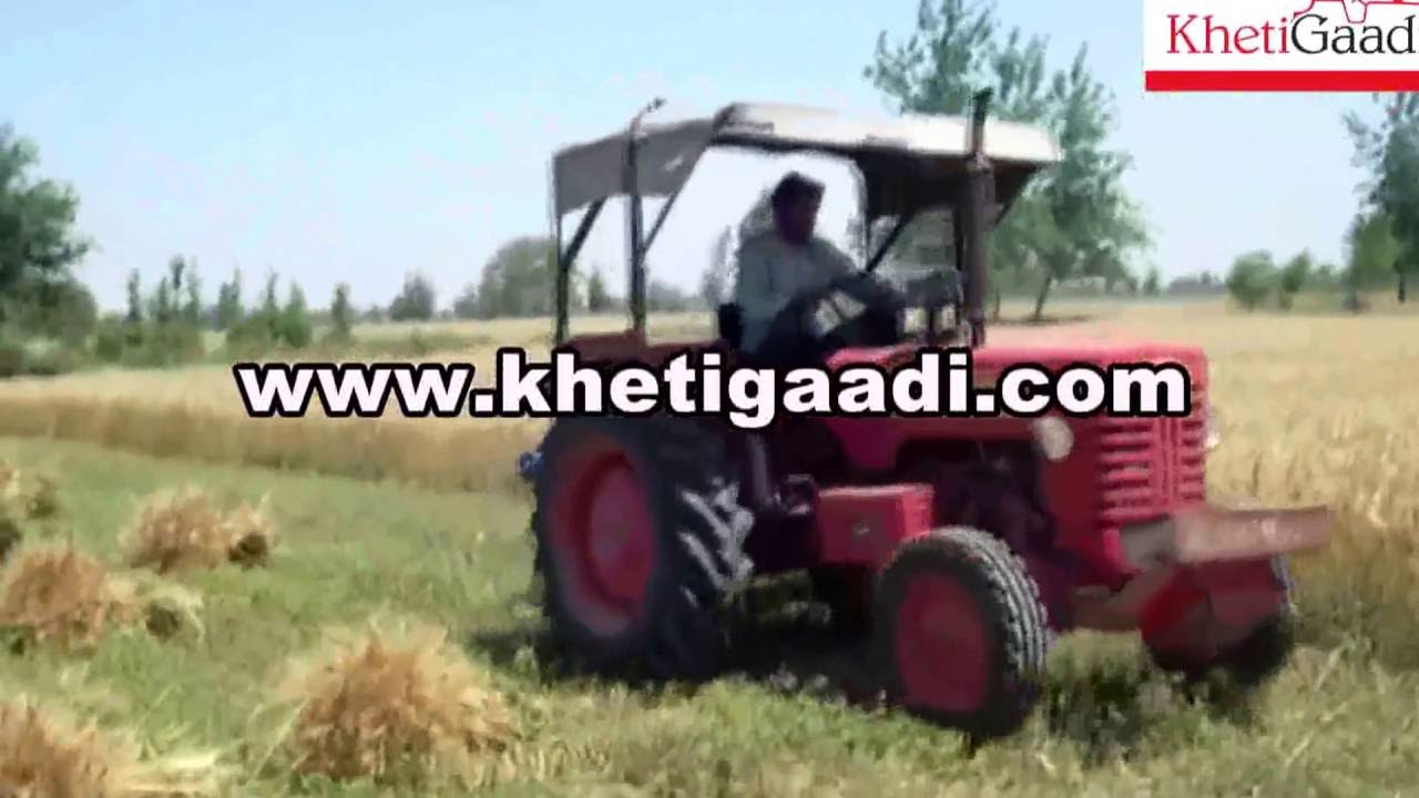 Mahindra Tractor 265 DI with Reaper Binder Machine in Farm